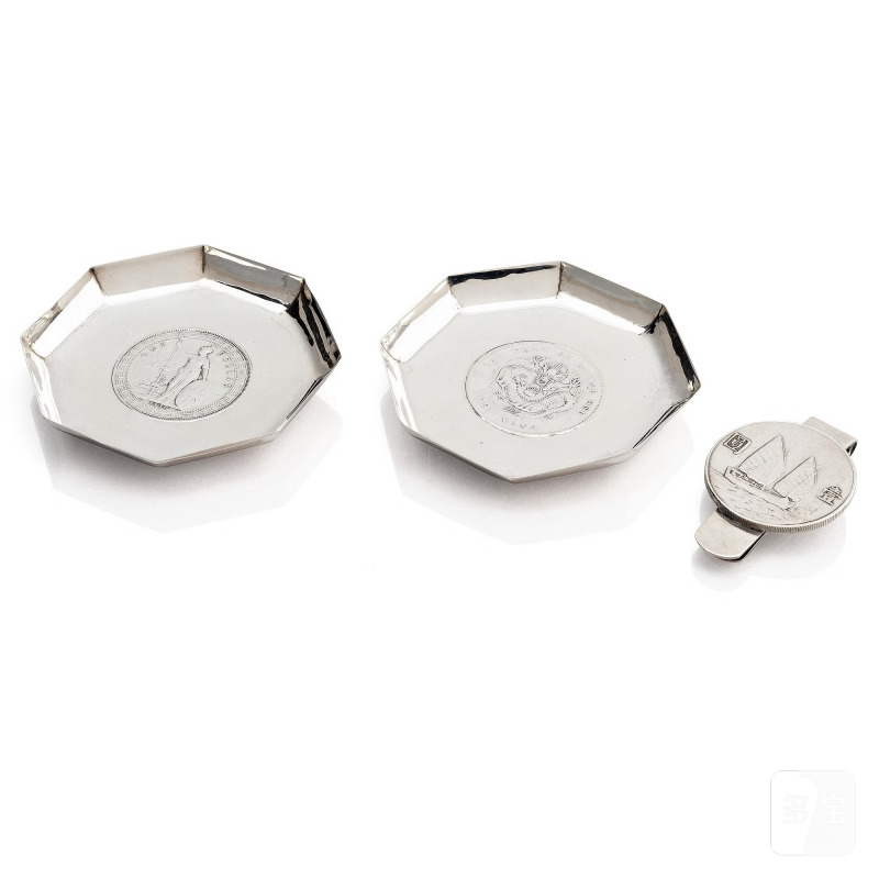 Two silver coasters and a money clip,
